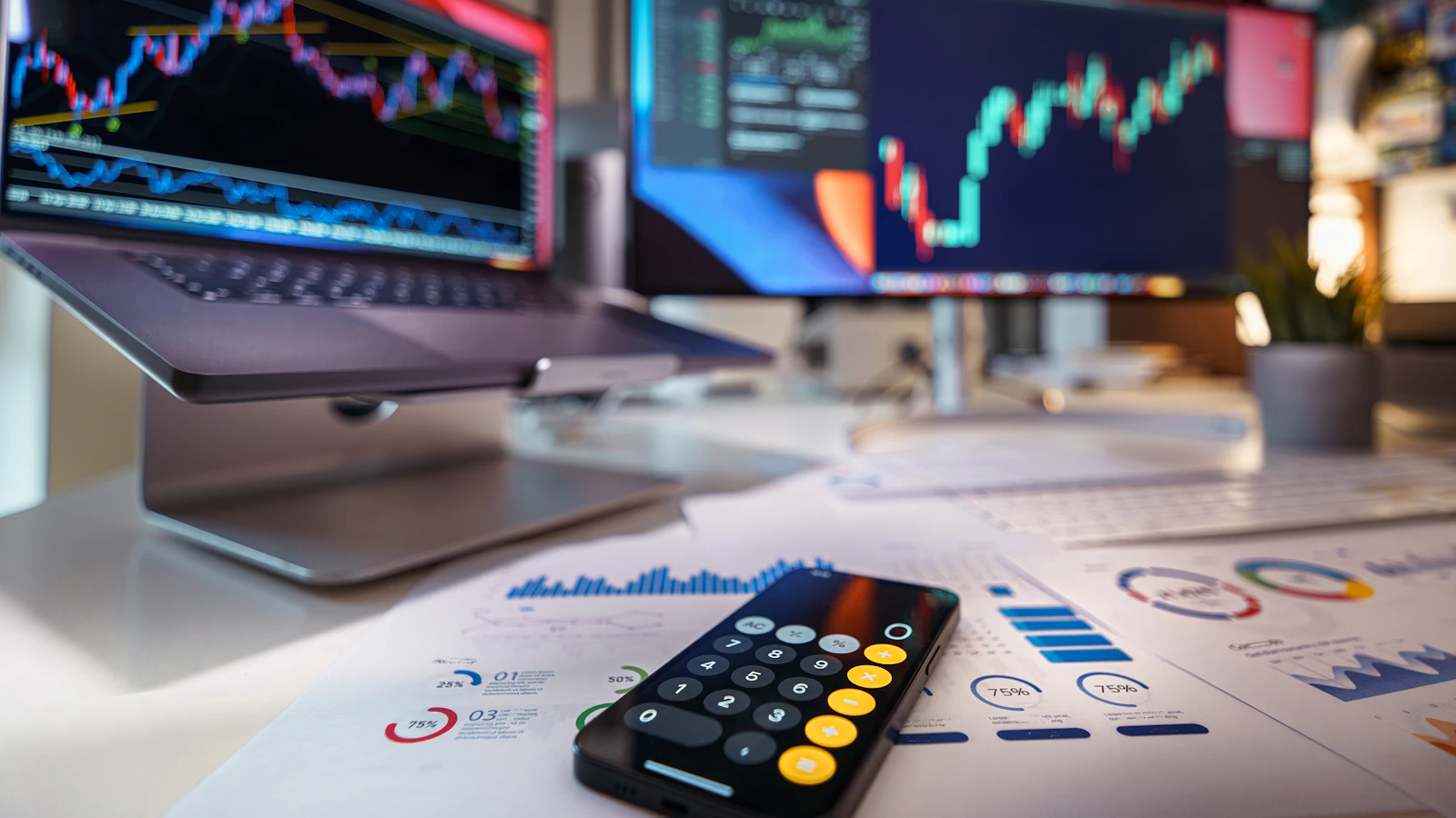 Masada akıllı telefon hesap makinesi, arkada finansal grafikler